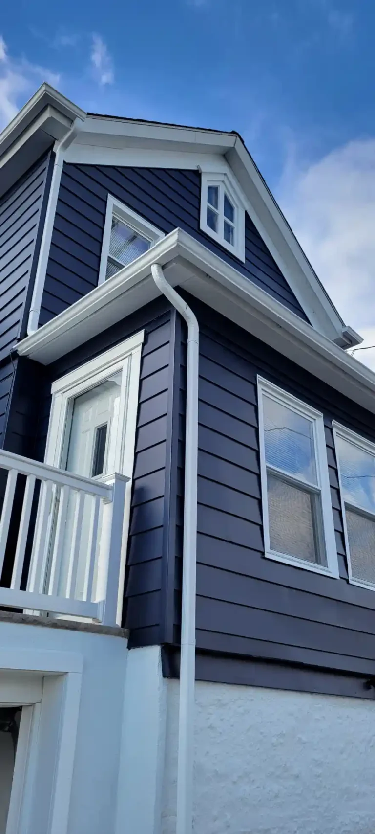 Exterior-House-painting-Dark-blue-aluminum-siding-white-gutters-windows-doors-trim-downspouts-foundation-1