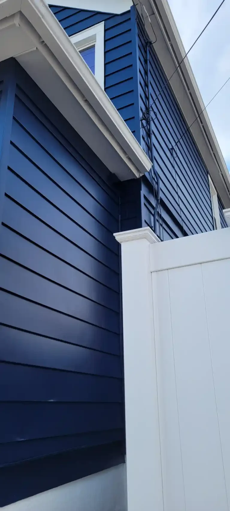 Exterior-House-painting-Dark-blue-aluminum-siding-white-gutters-windows-doors-trim-downspouts-foundation-2