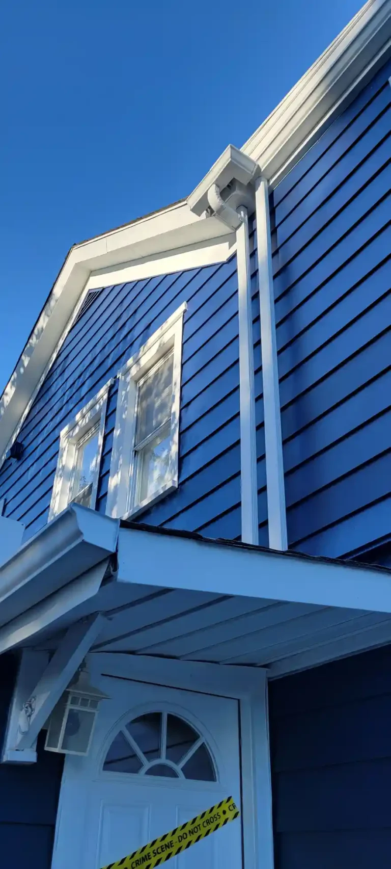 Exterior-House-painting-Dark-blue-aluminum-siding-white-gutters-windows-doors-trim-downspouts-foundation-5